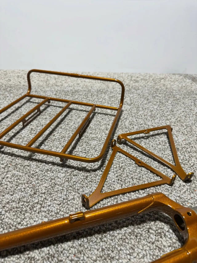 Bicycle fork & cargo rack assembly coated in Illusion Dorado + @coatingsbycoates HP Clear from @prismaticpowders 
#melrosemetalfinishing #prismaticpowders #bicycle #bikerack #passandstowracks